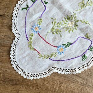 Vintage linen long doily/table runner with embroidered floral design.